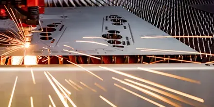 Laser cutting precision sheet metal components on the shop floor.