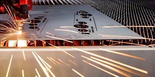 Laser cutting precision sheet metal components on the shop floor.